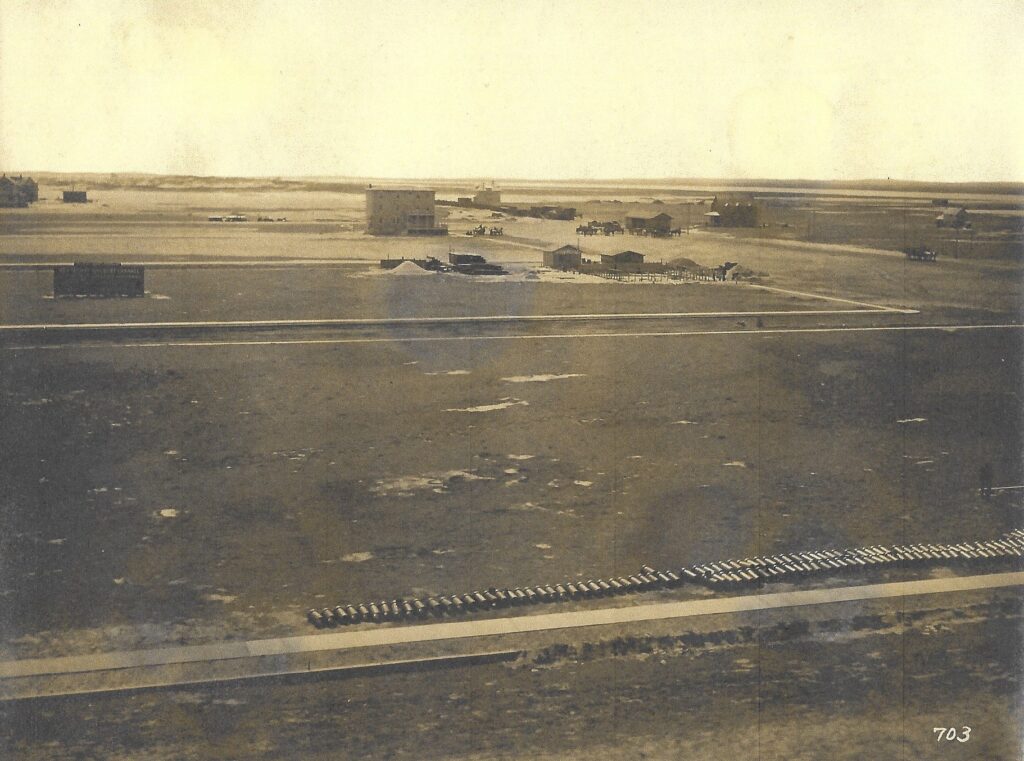 Three-story Fairview Hotel with wraparound porches on the first and second floors, shown standing alone on flat, undeveloped land in early Stone Harbor, circa 1909.
